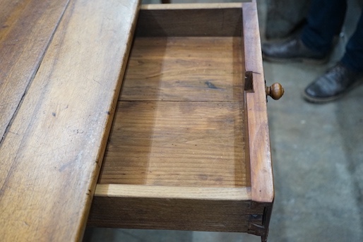 An early 19th century French rectangular fruitwood kitchen table fitted two drawers, length 201cm, depth 80cm, height 76cm